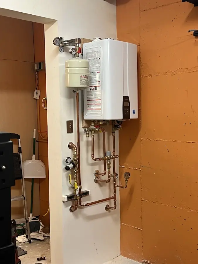 Plumbing technician inspecting water heater connections in Laguna Hills